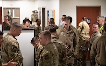 U.S. Air Force Airmen congregate before being processed through the personnel deployment function line.