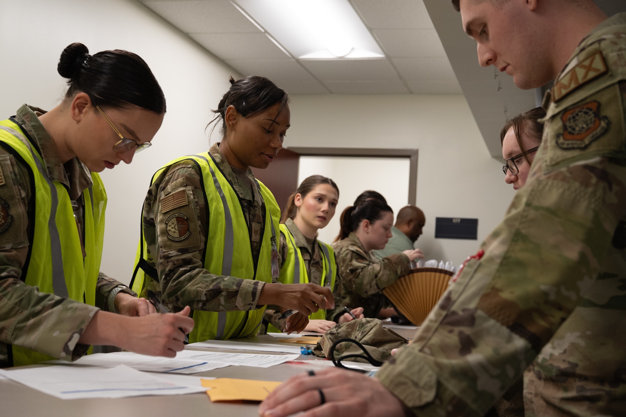 Joint Base Charleston Airmen personnel deployment function workers process U.S. Airman through the PDF line.