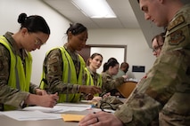 Joint Base Charleston Airmen personnel deployment function workers process U.S. Airman through the PDF line.