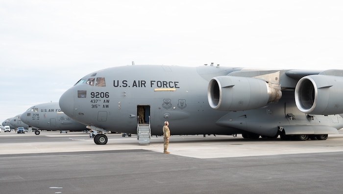 A C-17  GlobeMaster III is inspected by a U.S. Air Force Airman.