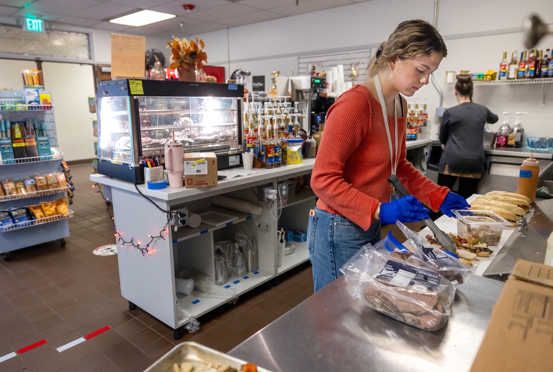 Barista Ava Walsh prepares fresh sandwiches for Anchors Aweigh customers at Puget Sound Naval Shipyard & Intermediate Maintenance Facility in Bremerton Washington, Nov. 13, 2025. The Kitsap County-based company opened two locations at PSNS & IMF late last year. (U.S. Navy photos by Wendy Hallmark)