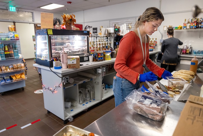 Barista Ava Walsh prepares fresh sandwiches for Anchors Aweigh customers at Puget Sound Naval Shipyard & Intermediate Maintenance Facility in Bremerton Washington, Nov. 13, 2025. The Kitsap County-based company opened two locations at PSNS & IMF late last year. (U.S. Navy photos by Wendy Hallmark)