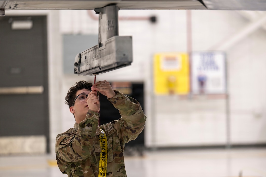 U.S. Air Force Airman 1st Class Aiden Boget, 18th Fighter Generation Squadron weapons load crew member, checks a missile rail for discrepancies on an F-16 Fighting Falcon during the 4th Quarter Load Competition at Eielson Air Force Base, Alaska, Jan. 9, 2026.