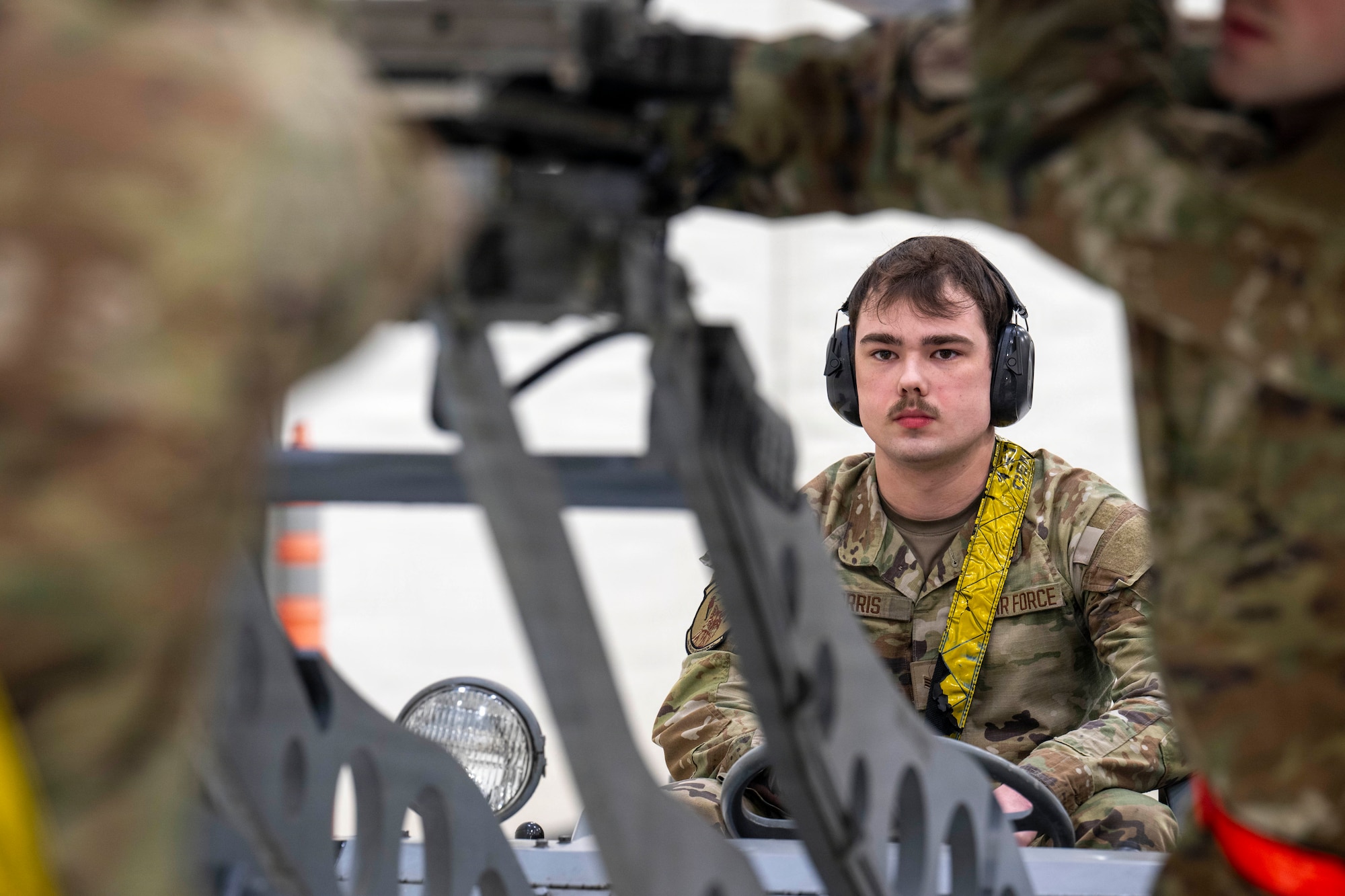 U.S. Air Force Senior Airman Peyton Morris, 18th Fighter Generation Squadron weapons load crew member, center, uses an MJ-1B lift truck to raise a dummy CATM-120B missile onto a F-16 Fighting Falcon during a 4th Quarter Load Competition at Eielson Air Force Base, Alaska, Jan. 9, 2026.