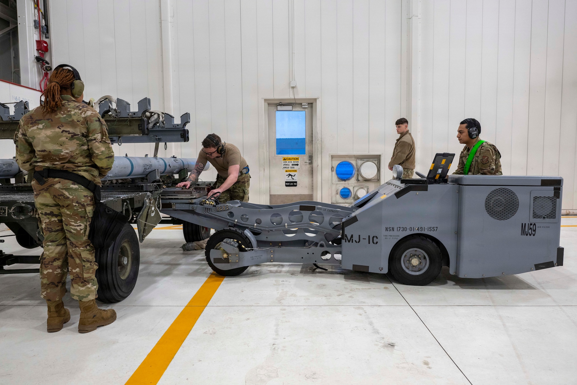 Airmen from the 356th Fighter Generation Squadron load a dummy CATM-120B missile onto an MJ-1C load truck during a 4th Quarter Load Competition at Eielson Air Force Base, Alaska, Jan. 9, 2026.