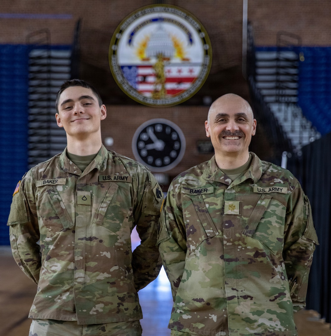 U.S Army Maj. Roy Baker, right, 45th Field Artillery, and Pfc. Radomir Baker, 2-245th Headquarters and Headquarters Company, pose for a photo in the District of Columbia Armory in Washington, D.C. Jan. 13, 2026. About 2,500 National Guard members are supporting the D.C. Safe and Beautiful mission providing critical support to the D.C. Metropolitan Police Department in ensuring the safety of all who live, work and visit the District. (U.S. Army National Guard Photo by Spc. Paris Hayes)