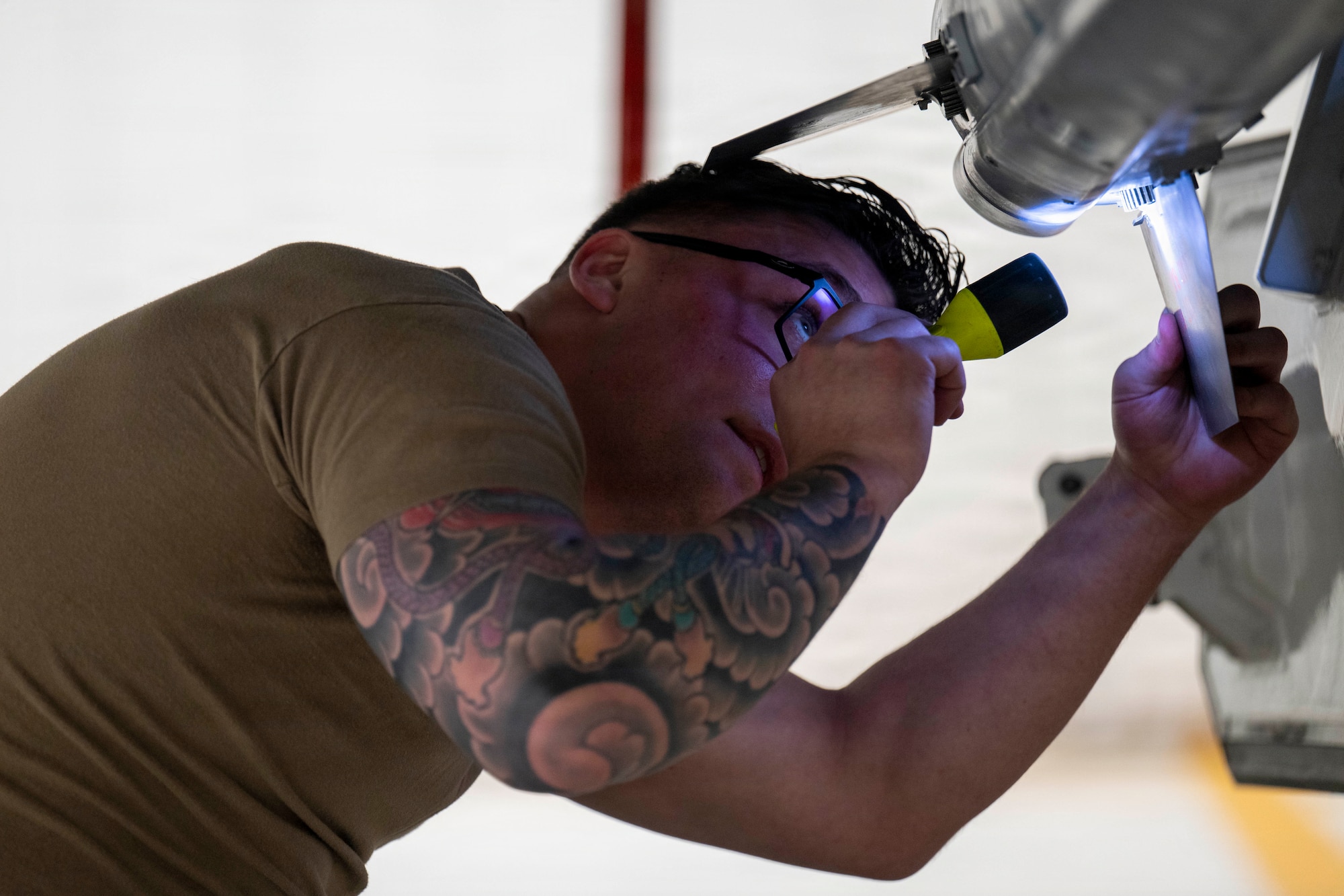 U.S. Air Force Tech. Sgt. Austin Adkins, 356th Fighter Generation Squadron weapons load crew chief, checks for discrepancies on a dummy CATM-120B missile during the 4th Quarter Load Competition at Eielson Air Force Base, Alaska, Jan. 9, 2026.