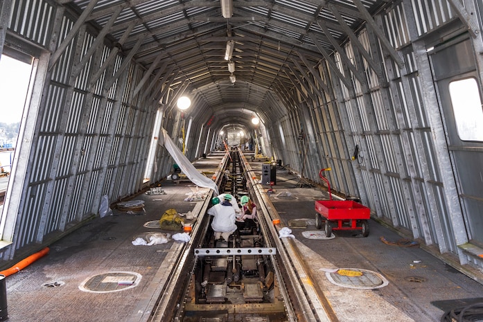Aircraft Launch and Recovery team members from Shop 38, Marine Machinist, work to align one of three catapults aboard USS Nimitz (CVN 68) Jan. 7, 2024, during a six-month planned incremental availability at Puget Sound Naval Shipyard & Intermediate Maintenance Facility in Bremerton, Washington. (U.S. Navy photo by Wendy Hallmark)