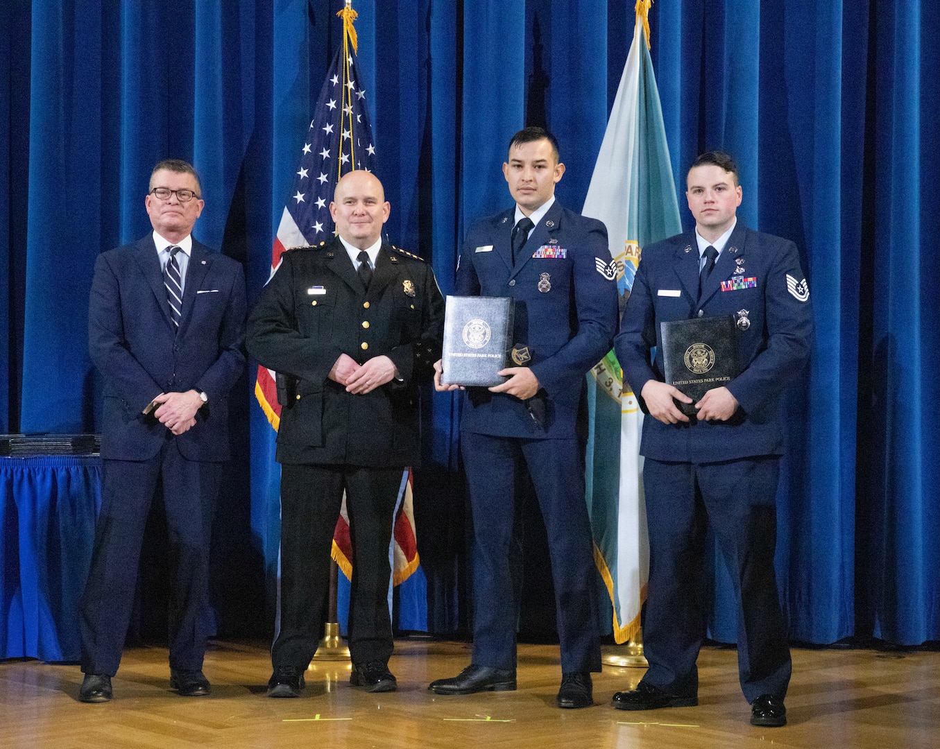 U.S. Air Force Staff Sgt. Hector Amaya, second from right, and Tech. Sgt. Dylan Chadbourne, right, assigned to the 113th Security Forces Squadron, Joint Task Force – District of Columbia, received awards during a Winter Ceremony held by the U.S. Park Police in Washington, D.C. Jan. 9, 2026. About 2,500 National Guard members are supporting the D.C. Safe and Beautiful mission providing critical support to the D.C. Metropolitan Police Department in ensuring the safety of all who live, work and visit the District. (U.S. Army National Guard Photo by Spc. Paris Hayes)