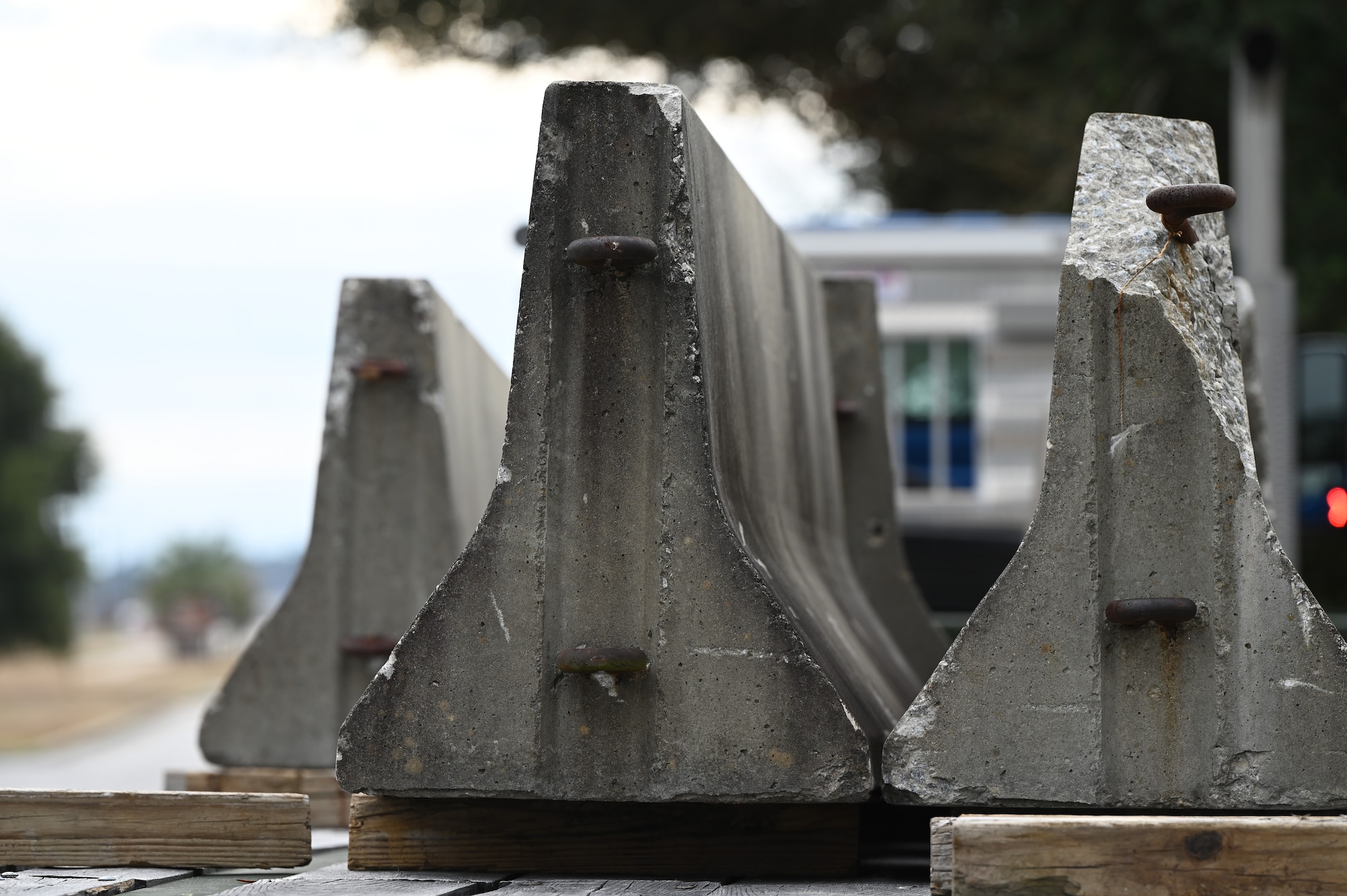 Concrete barriers sit atop the back of a semi-truck.