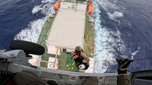 A U.S. Navy MH-60 Knighthawk helicopter crew from Helicopter Sea Combat Squadron 25 hoists a 60-year-old ill mariner from the 459-foot U.S.-flagged cable-laying ship Decisive on Jan. 13, 2026, about 110 miles off Guam for further transport to Guam for a high level of medical care. U.S. Coast Guard Joint Rescue Sub-Center Guam watchstanders received the medical evacuation request from the captain of the Decisive at approximately 10:10 a.m. local time on Jan. 12 while the ship was over 400 nautical miles offshore of Guam, outside of hoist-capable aircraft range, and worked to coordinate the medevac. (U.S. Navy photo by HSC-25)