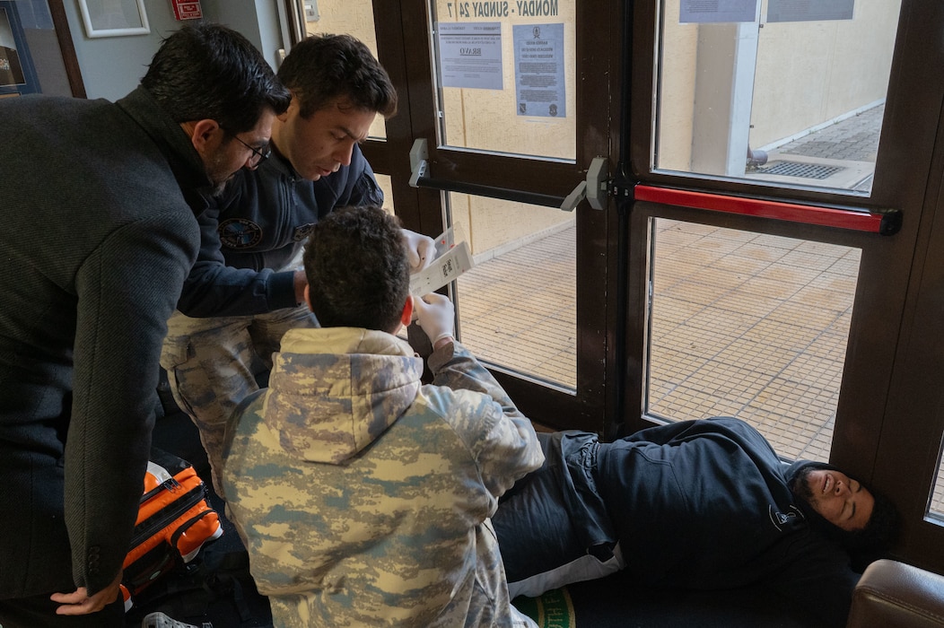 Turkish Air Force members prepare simulated victim for transport.