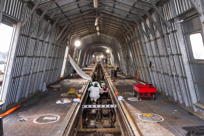 Aircraft Launch and Recovery team members from Shop 38, Marine Machinist, work to align one of three catapults aboard USS Nimitz (CVN 68) Jan. 7, 2024, during a six-month planned incremental availability at Puget Sound Naval Shipyard & Intermediate Maintenance Facility in Bremerton, Washington. (U.S. Navy photo by Wendy Hallmark)