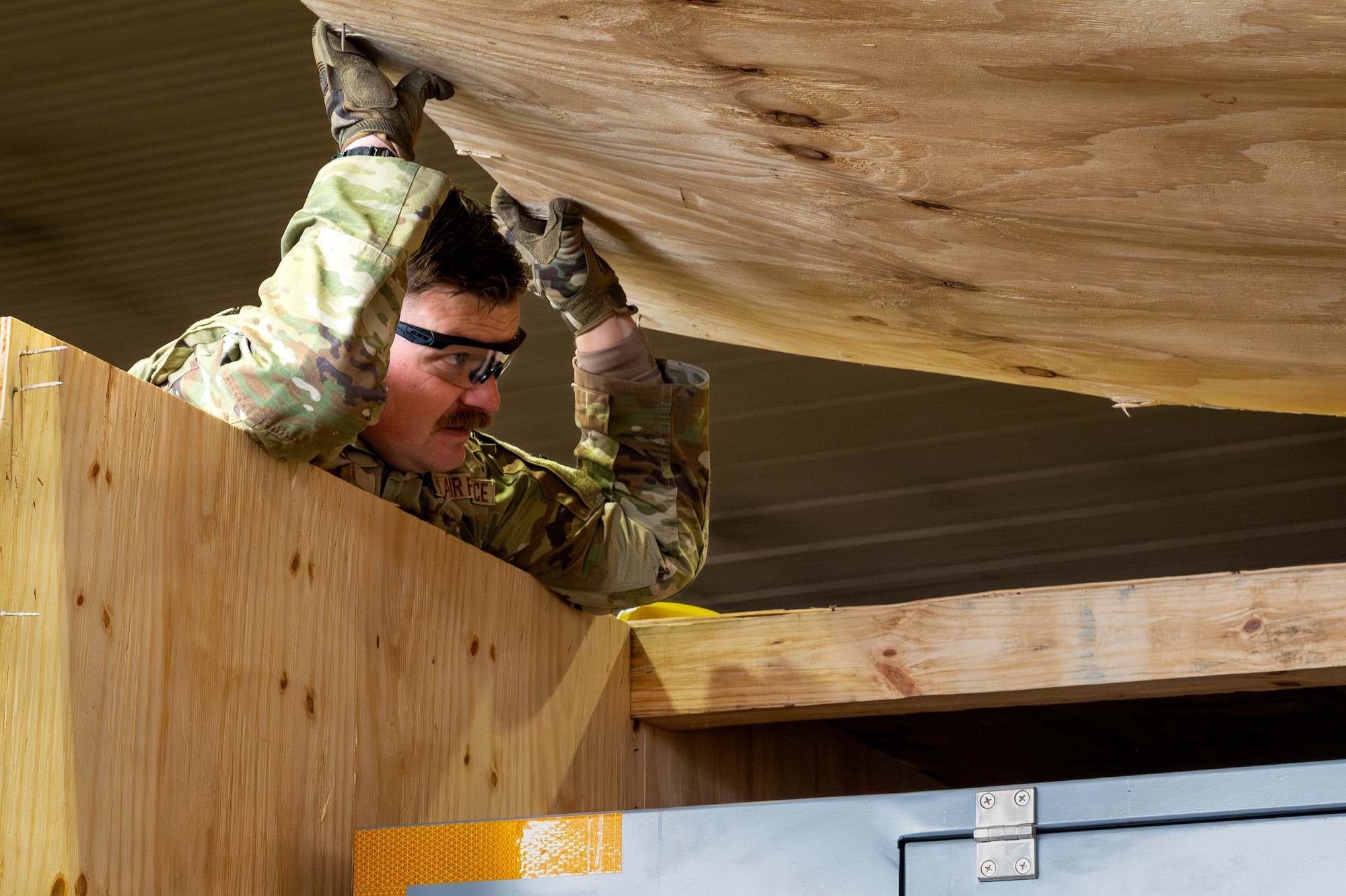 U.S. Air Force Tech. Sgt. Derek Garner, 35th Maintenance Group maintenance Airman, lifts the lid off a crate containing F-35A Lightning II support equipment at Misawa Air Base, Japan, Jan. 13, 2026.