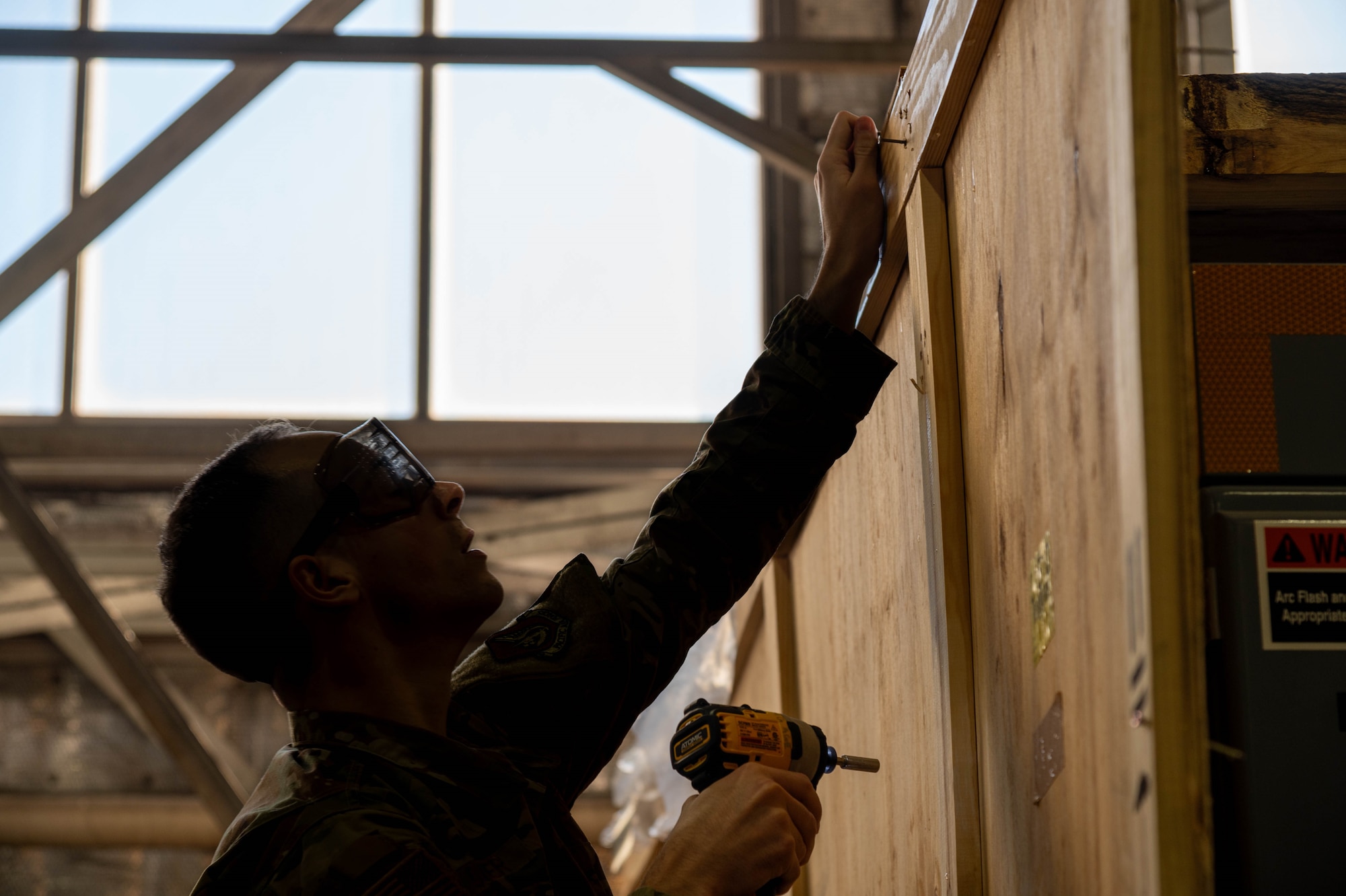 U.S. Air Force Staff Sgt. Preston Quittner,13th Fighter Generation Squadron weapons load crew member, removes a screw from a crate containing F-35A Lightning II support equipment at Misawa Air Base, Japan, Jan. 13, 2026.