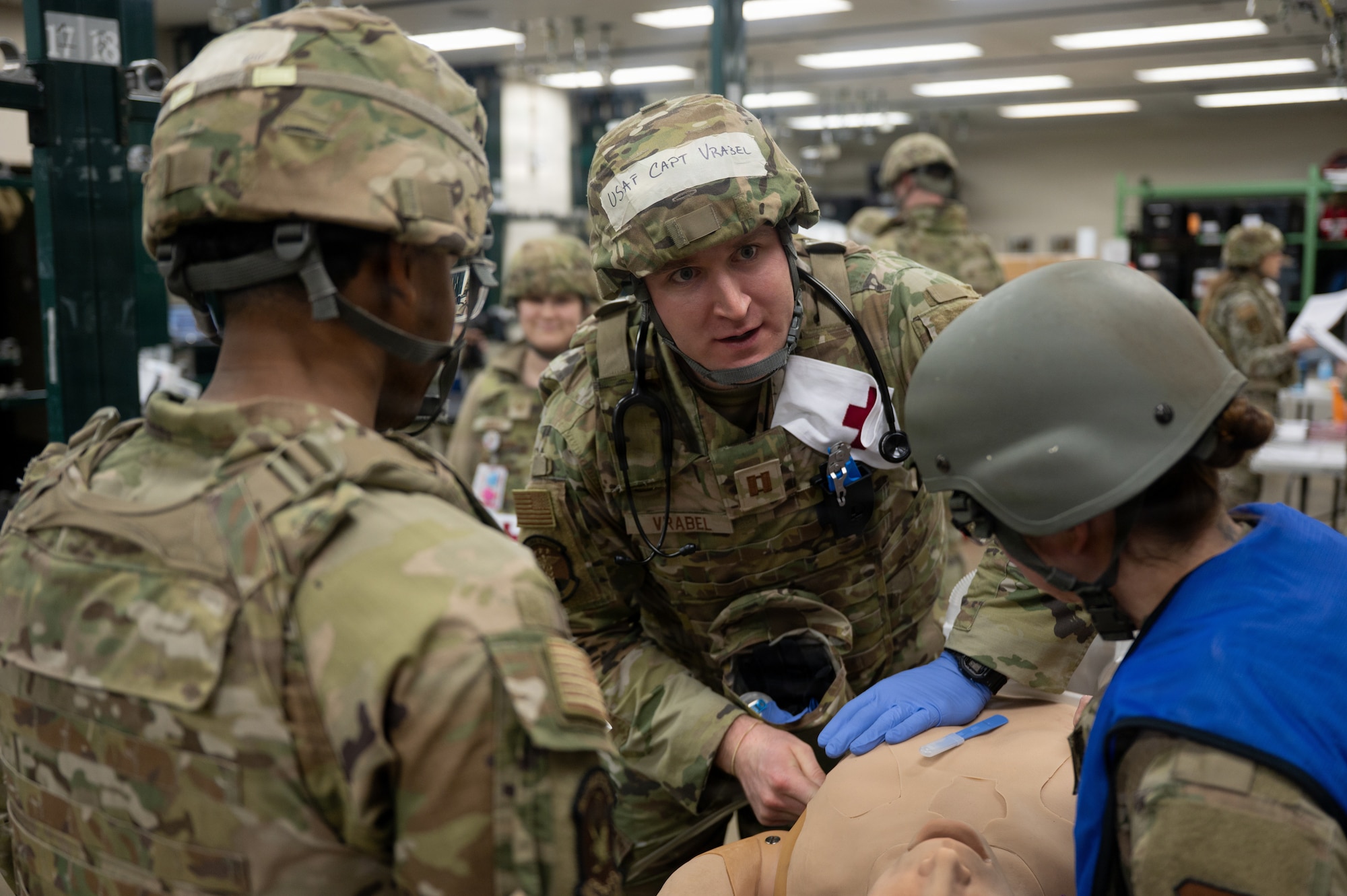U.S. Air Force Capt. Jarrett Vrabel, 35th Medical Group pediatrics medical director, demonstrates  medical procedures on a training mannequin during exercise Sprint 26-2.
