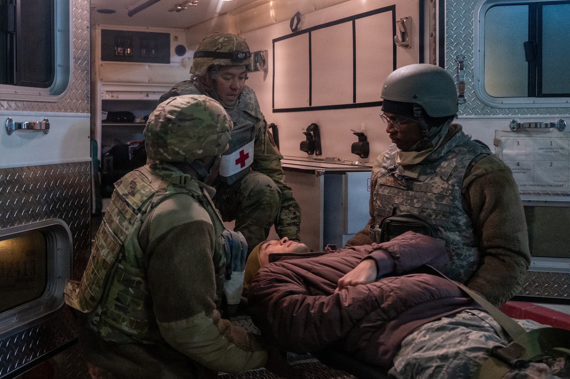 U.S. Airmen assigned to the 35th Medical Group MDG) load a simulated casualty into an ambulance during exercise Sprint 26-2.