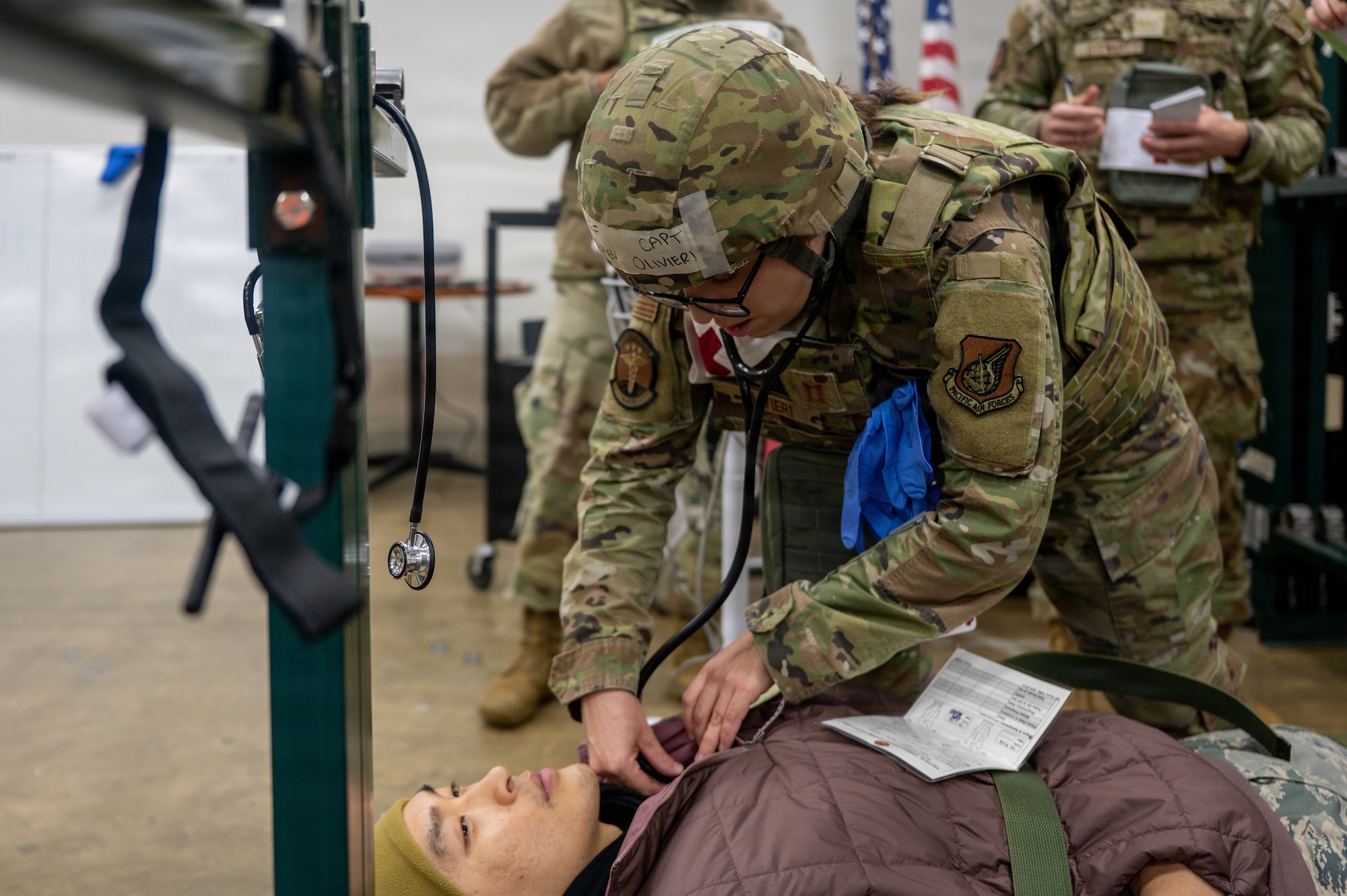 U.S. Air Force Capt. Lauren Olivieri, 35th Medical Group Family Health medical director, performs medical exam procedures on a simulated casualty during exercise Sprint 26-2.
