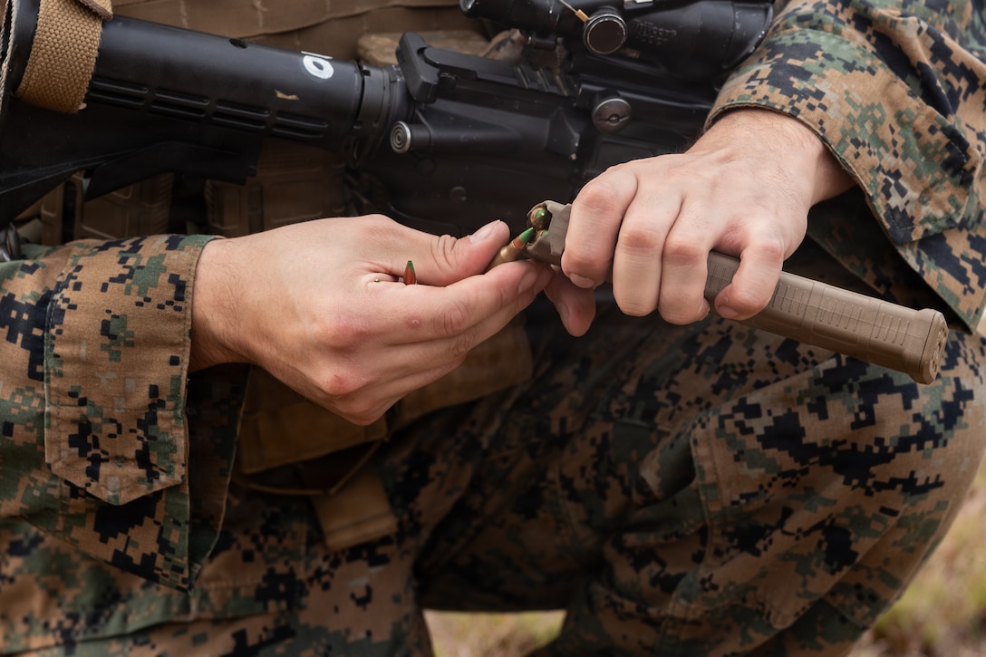 U.S. Marine Corps Lance Cpl. Alejandro Mata, a motor vehicle operator with Truck Company, 23rd Marine Regiment, 4th Marine Division, load ammunition into a magazine during annual training at Fort Polk, Louisiana, Jan. 9, 2026. Marines conducted a known distance range to enhance marksmanship fundamentals and combat readiness. (U.S. Marine Corps photo by Lance Cpl. Claire Cheney)