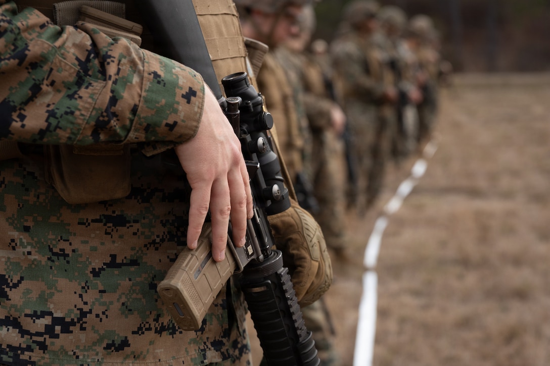 U.S. Marines with Truck Company, 23rd Marine Regiment, 4th Marine Division, wait for the next iteration of fire during annual training at Fort Polk, Louisiana, Jan. 9, 2026. The known distance range enhances marksmanship fundamentals and combat readiness. (U.S. Marine Corps photo by Lance Cpl. Claire Cheney)