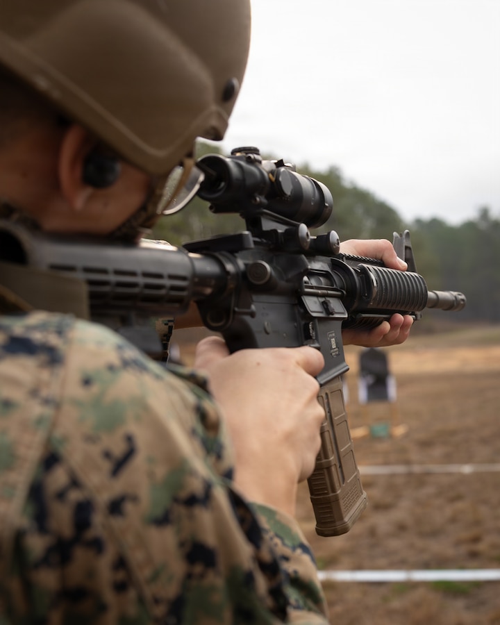 A U.S. Marine with Truck Company, 23rd Marine Regiment, 4th Marine Division, fire an M4 carbine at targets during annual training at Fort Polk, Louisiana, Jan. 9, 2026. The known distance range enhances marksmanship fundamentals and combat readiness. (U.S. Marine Corps photo by Lance Cpl. Claire Cheney)