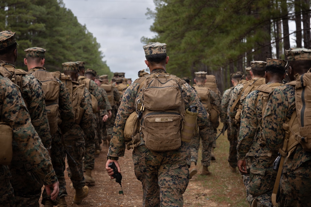 U.S. Marine Corps Staff Sgt. Robert J. Mion, a motor vehicle operator, with Truck Company, 23rd Marine Regiment, 4th Marine Division, participates in 7-kilometer hike, Fort Polk, Louisiana, Jan. 9, 2026. Marines with Truck company departed a known distance range, which enhanced marksmanship fundamentals and combat readiness. (U.S. Marine Corps photo by Lance Cpl. Claire Cheney)