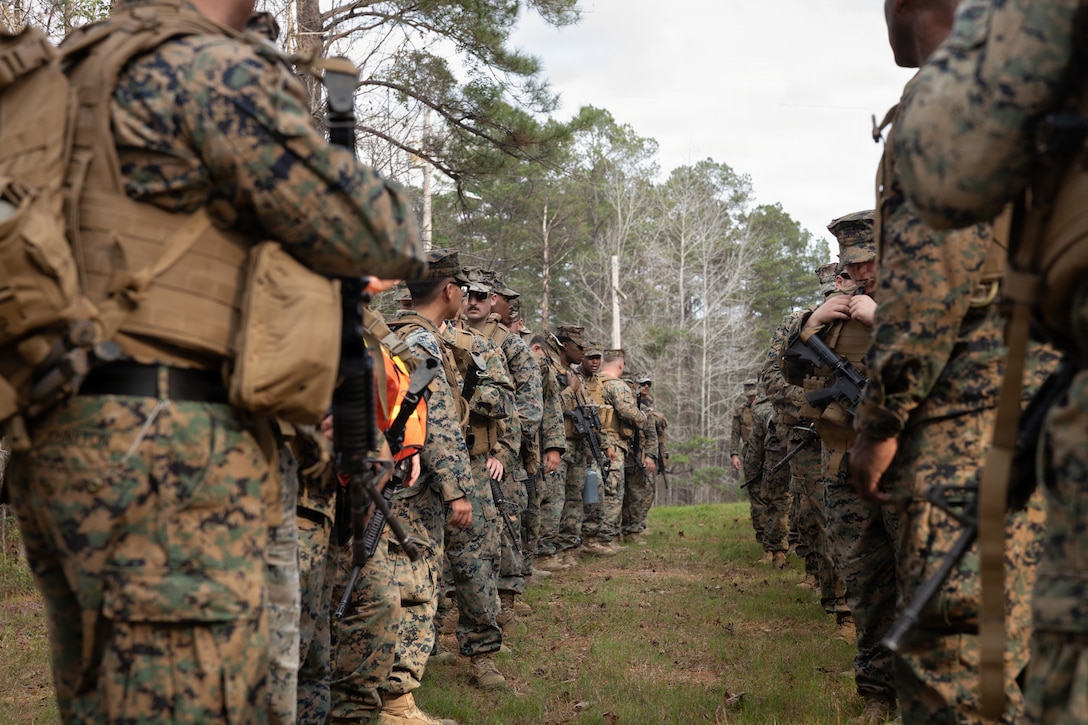 U.S. Marines with Truck Company, 23rd Marine Regiment, 4th Marine Division, prepare for a 7-kilometer hike at Fort Polk, Louisiana, Jan. 9, 2026. Marines with Truck company departed a known distance range, which enhanced marksmanship fundamentals and combat readiness. (U.S. Marine Corps photo by Lance Cpl. Claire Cheney)