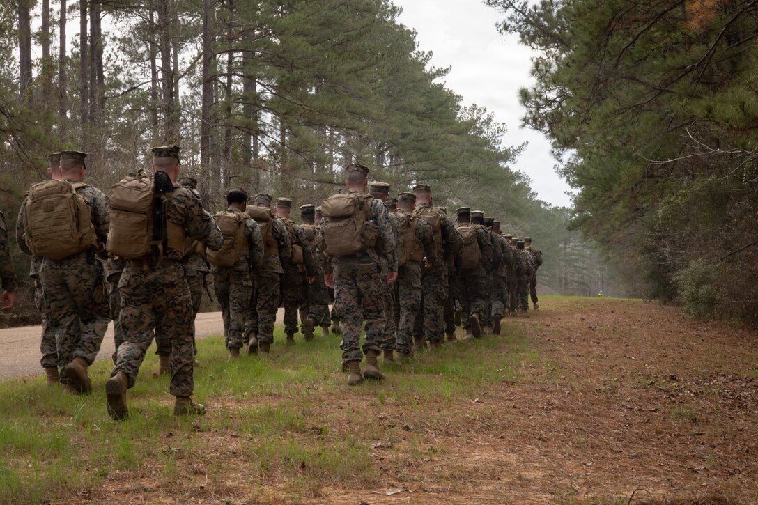 U.S. Marines with Truck Company, 23rd Marine Regiment, 4th Marine Division, participate in a 7-kilometer hike, Fort Polk, Louisiana, Jan. 9, 2026. Marines with Truck company departed a known distance range, which enhanced marksmanship fundamentals and combat readiness. (U.S. Marine Corps photo by Lance Cpl. Claire Cheney)