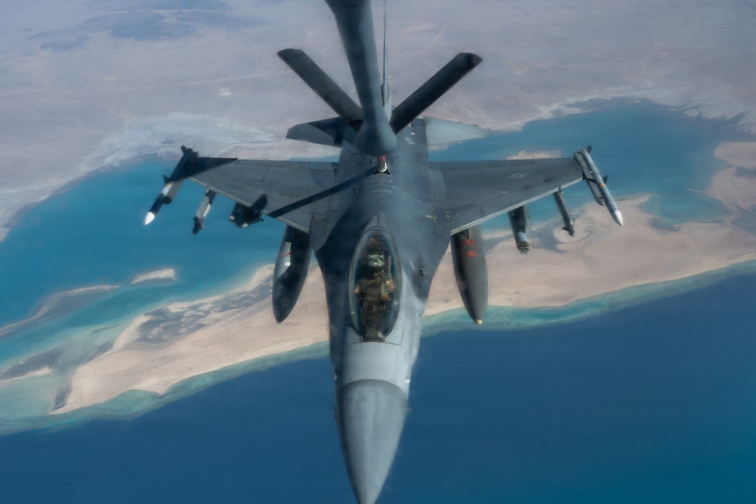 A U.S. Air Force F-16 Fighting Falcon aircraft receives fuel from a KC-135 Stratotanker aircraft assigned to the 74th Expeditionary Air Refueling Squadron during a mission in the U.S. Central Command area of responsibility, Jan 7, 2026. The KC-135 Stratotanker sustains air operations through in-flight refueling extending the range of military aircraft operating in the region. (U.S. Air Force photo by Airman 1st Class Travis Knauss)