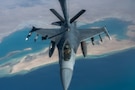 A U.S. Air Force F-16 Fighting Falcon aircraft receives fuel from a KC-135 Stratotanker aircraft assigned to the 74th Expeditionary Air Refueling Squadron during a mission in the U.S. Central Command area of responsibility, Jan 7, 2026. The KC-135 Stratotanker sustains air operations through in-flight refueling extending the range of military aircraft operating in the region. (U.S. Air Force photo by Airman 1st Class Travis Knauss)
