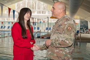 Image of lifeguard and Airman shaking hands.