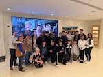 Dr. Shane Wines (far left) alongside staff and students from Calvert High School, his former school where he taught for 10 years, on a field trip to Naval Surface Warfare Center, Carderock Division in West Bethesda, Md., in December 2025.