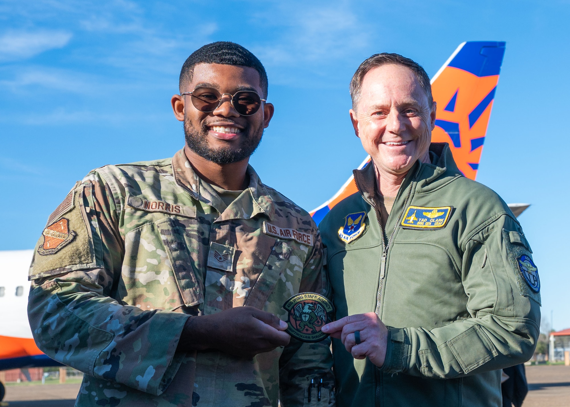 U.S. Air Force Brig. Gen. Tad Clark, director of Regional Affairs for the Deputy Under Secretary of the Air Force, International Affairs, and Staff Sgt. John Norris, 42d Air Base Wing occupational safety technician, display a 42d ABW Wing Staff Agency patch at Maxwell Air Force Base, Alabama, Jan. 13, 2026.