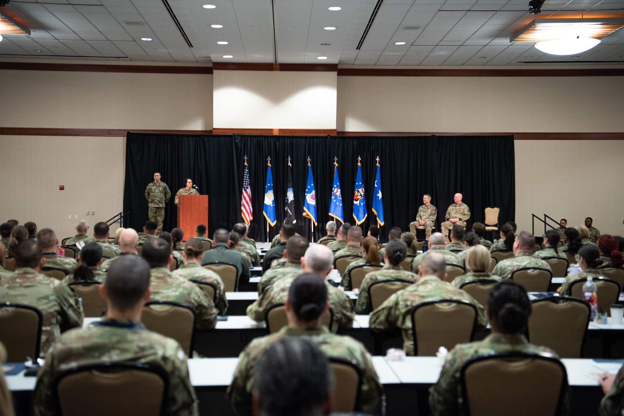 Image of a ceremony and Airmen speaking.