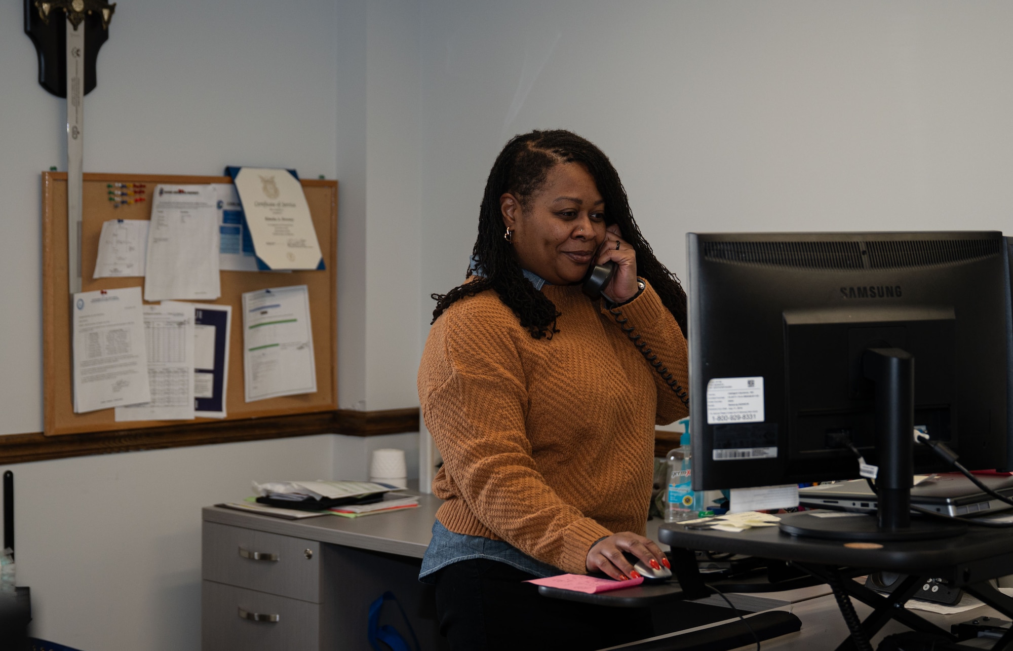 Kimeka Downey, 436th Operations Support Squadron host aviation resources support assistant chief, talks on the phone at Dover Air Force Base, Delaware, Jan. 14, 2026. Downey has been at Dover AFB since 2001, one year after she joined the Air Force Reserve. In 2016, she retired at E-6 and continues to serve as a civilian. (U.S. Air Force photo by Airman 1st Class Liberty Kuhn)