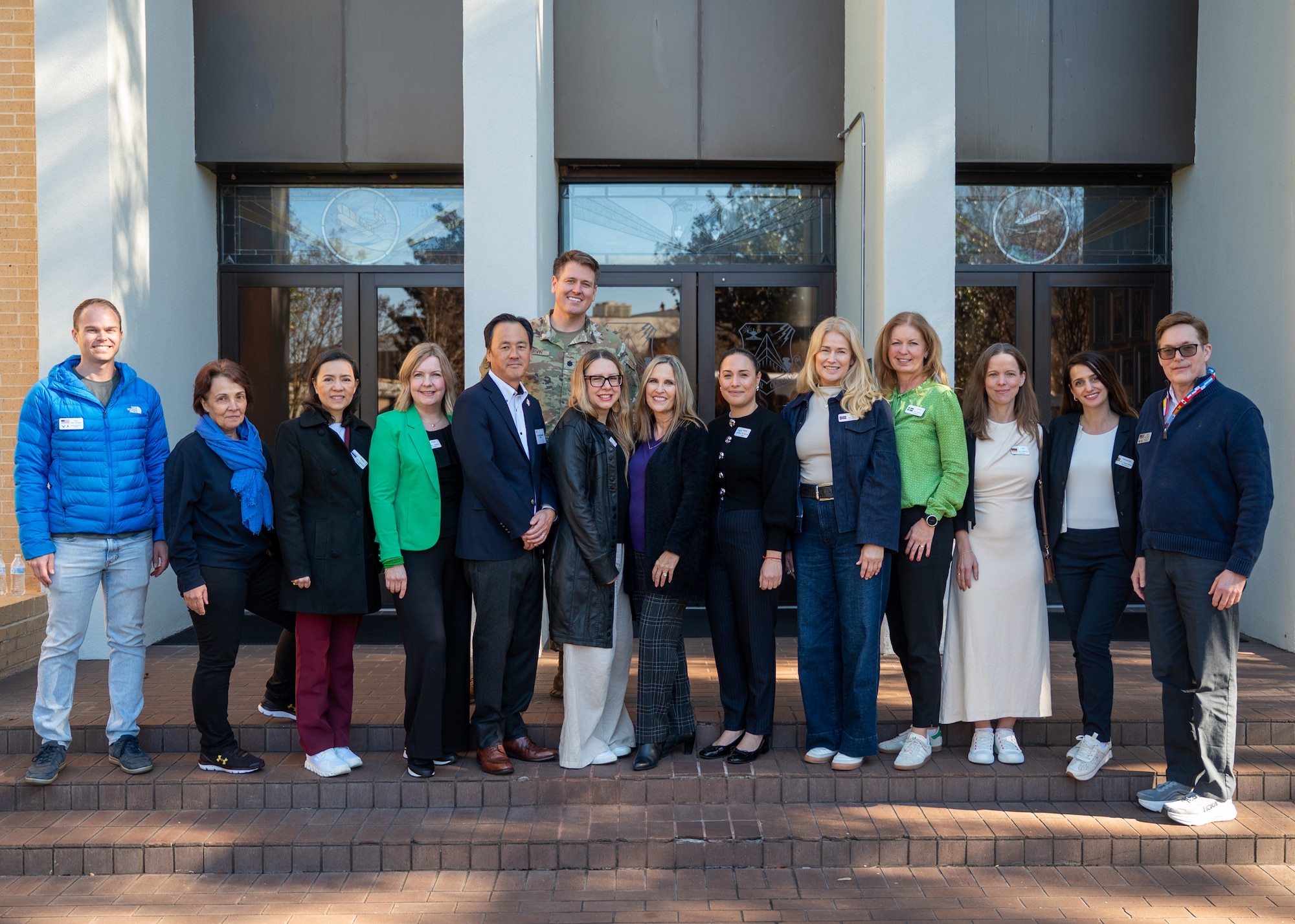 Members from Air University’s Foreign Liaison Office pose with International Air and Space Attaché spouses outside the Governor’s Mansion in Montgomery, Alabama, Jan. 13, 2026.