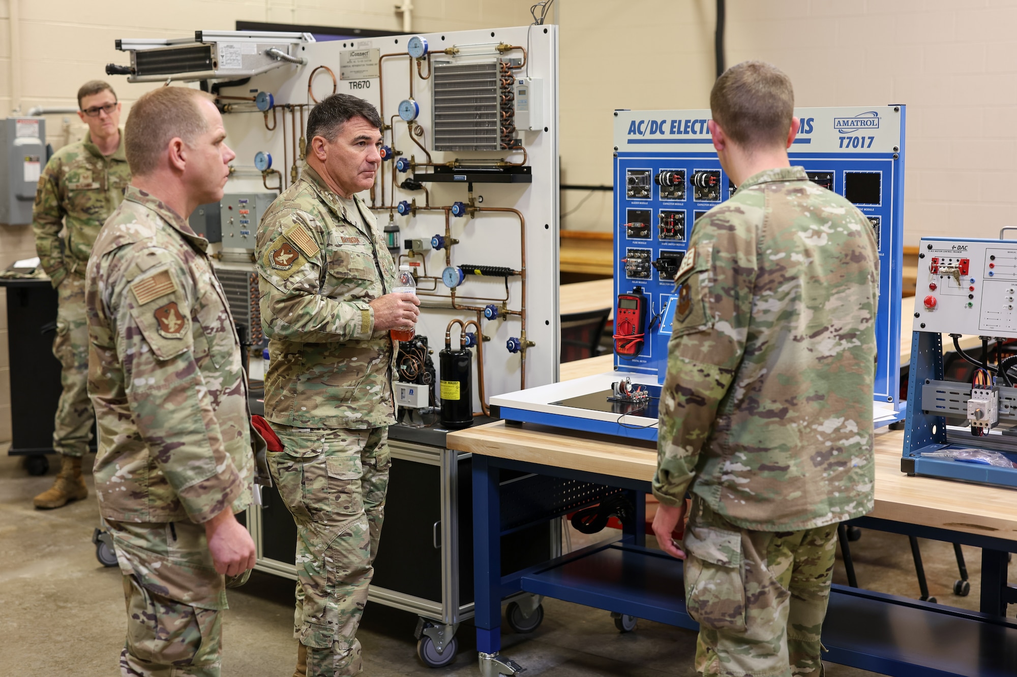 U.S. Air Force Maj. Gen. Wolfe Davidson, Second Air Force commander, and U.S. Air Force Chief Master Sgt. Colin Fleck, Second Air Force command chief, observe an AC/DC Electrical Systems Trainer as U.S. Air Force Tech. Sgt. Austin Sutton, 361st Training Squadron Aerospace Ground Equipment assistant flight chief, explains its capabilities at Sheppard Air Force Base, Texas, Jan. 15, 2026.