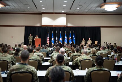 Image of a ceremony and Airmen speaking.