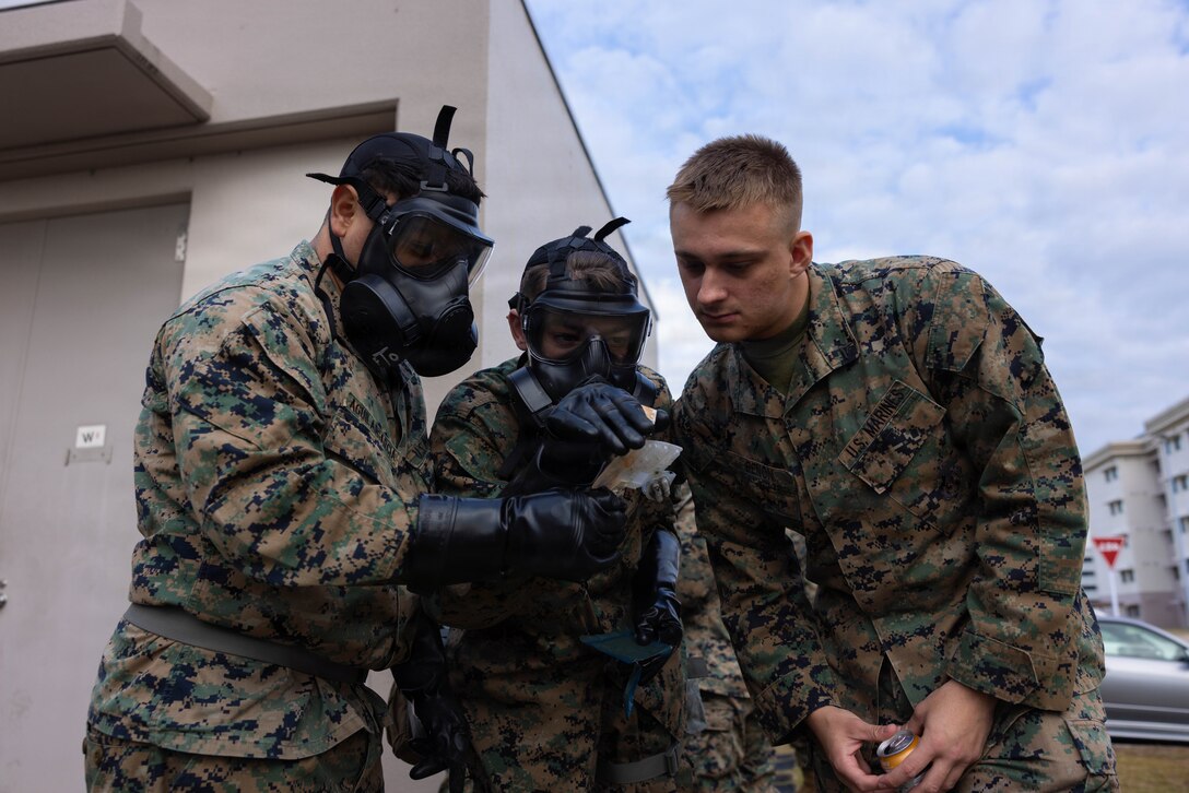 U.S. Marine Corps Lance Cpl. Christopher Benon, right, a chemical, biological, radiological, and nuclear (CBRN) specialist with Marine Wing Support Squadron (MWSS) 171, Marine Aircraft Group 12, 1st Marine Aircraft Wing, assists Marines with identifying a type of chemical attack during CBRN training at Marine Corps Air Station Iwakuni, Japan, Nov. 24, 2025. Marines use the M256A1 kit to detect and identify chemical warfare agents in the field. (U.S. Marine Corps photo by Lance Cpl. Ella Cadby)