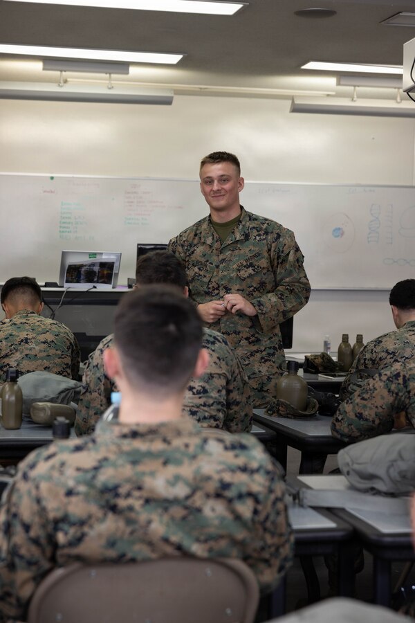 U.S. Marine Corps Lance Cpl. Christopher Benon, a chemical, biological, radiological, and nuclear (CBRN) specialist with Marine Wing Support Squadron (MWSS) 171, Marine Aircraft Group 12, 1st Marine Aircraft Wing, teaches Marines about the components of biological warfare at Marine Corps Air Station Iwakuni, Japan, Nov. 24, 2025. CBRN training is crucial for Marines to remain capable, confident and operation ready in any environment. (U.S. Marine Corps photo by Lance Cpl. Ella Cadby)