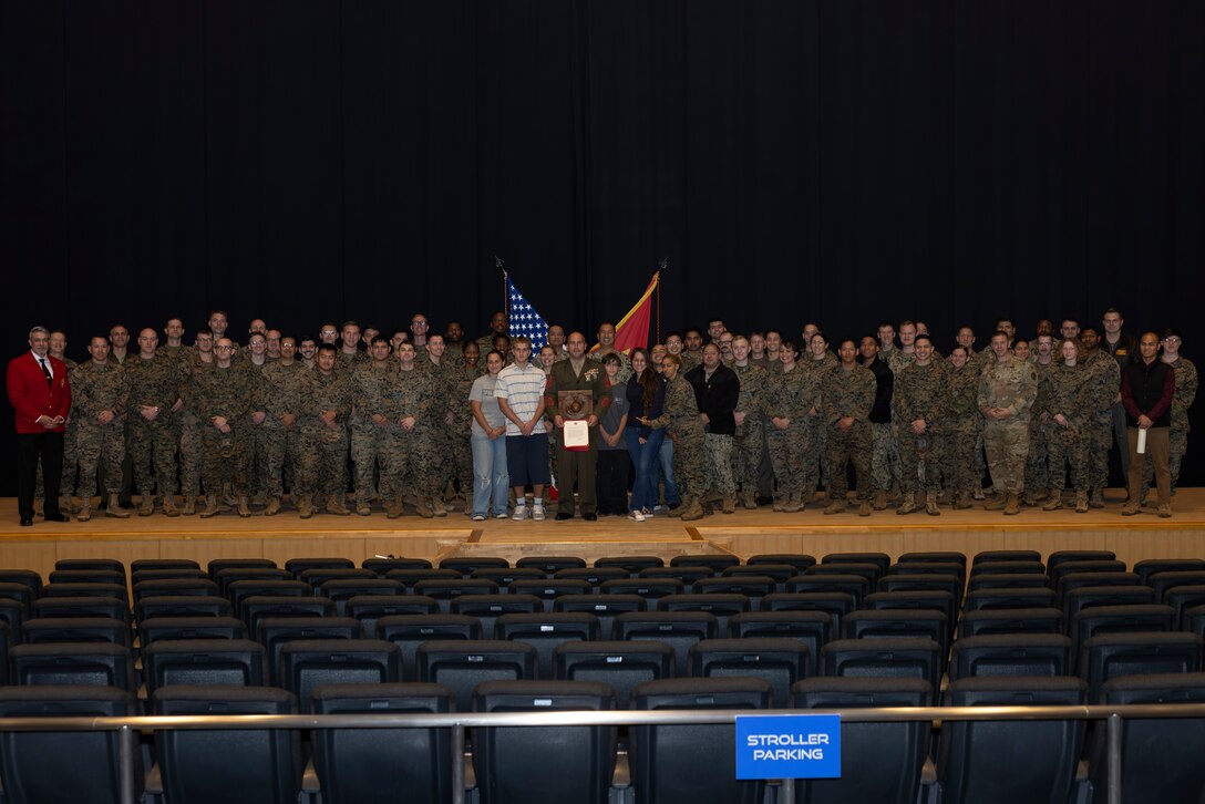 U.S. service members and guests with Marine Corps Air Station Iwakuni pose for a group photo during the Gunnery Sgt. Carlos N. Hathcock II award ceremony at MCAS Iwakuni, Japan, Nov. 4, 2025. Gunnery Sgt. Robert Navarro was awarded the Gunnery Sgt. Carlos N. Hathcock Il award for his prestigious work and dedication to improving marksmanship of the indoor small arms range and efficiently training rifle and pistol qualifications. (U.S. Marine Corps photo by Lance Cpl. Isaac De Leon)