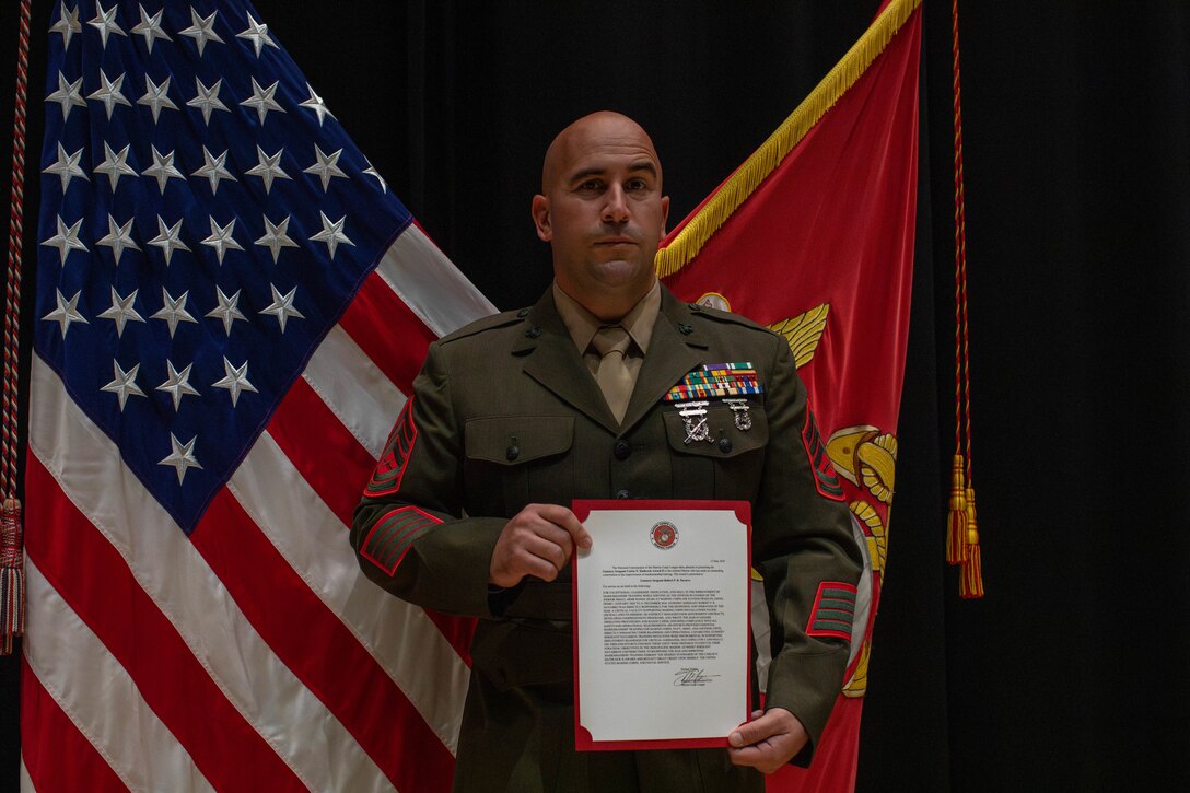Award recipient, U.S. Marine Corps Gunnery Sgt. Robert Navarro, the officer in charge of the indoor small arms range with Headquarters and Headquarters Squadron, Marine Corps Air Station, and native to Oceanside, poses for a photo after the Gunnery Sgt. Carlos N. Hathcock II award ceremony at MCAS Iwakuni, Japan, Nov. 4, 2025. Gunnery Sgt. Navarro was awarded the Gunnery Sgt. Carlos N, Hathcock II award for his prestigious work and dedication to improving marksmanship of the ISAR and efficiently training rifle and pistol qualifications. (U.S. Marine Corps photo by Lance Cpl. Siwan Lewis)