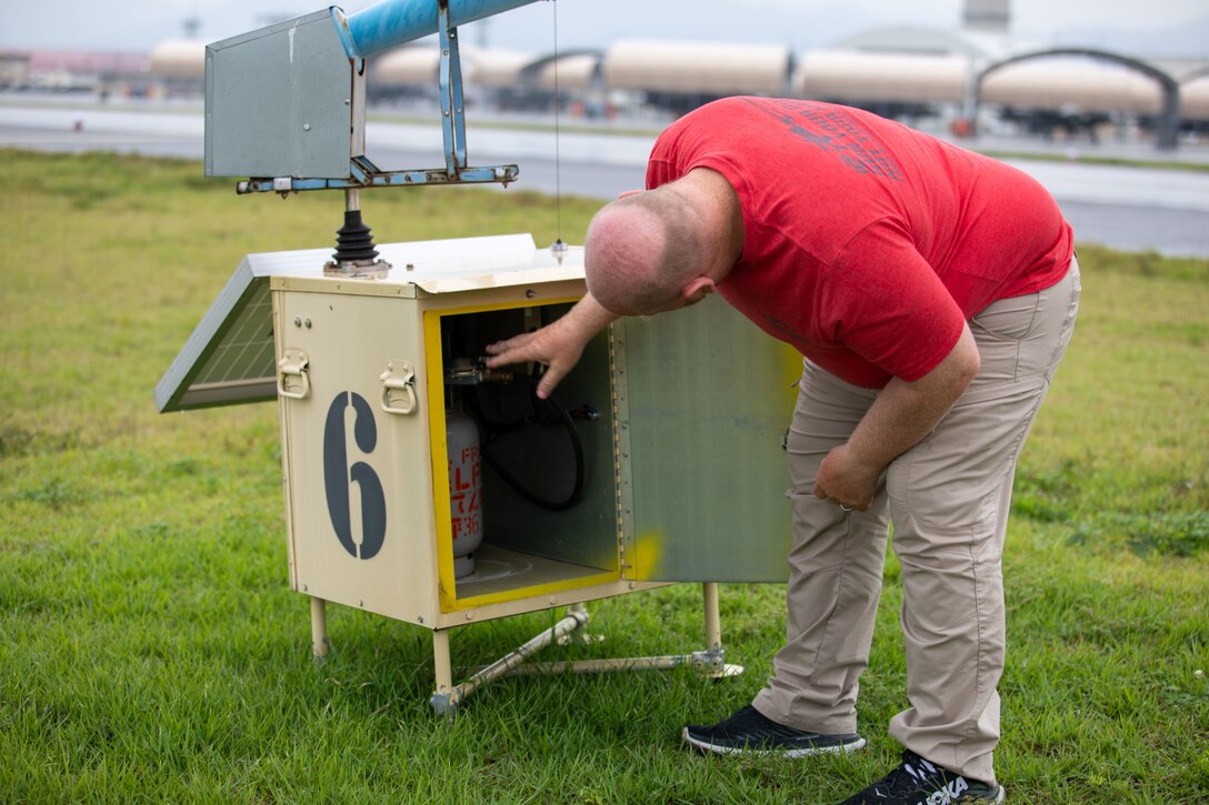 Edward Hosack, the Bird/Wildlife Aircraft Strike Hazard team supervisor for Marine Corps Air Station Iwakuni, inspects a propane-powered cannon during a BASH patrol of the flightline at MCAS Iwakuni, Japan, Oct. 3, 2025. The MCAS Iwakuni BASH program is designed to keep runways and the surrounding area free of any wildlife that could pose a threat to daily flight operations. (U.S. Marine Corps photo by Sgt. Randall Whiteman)
