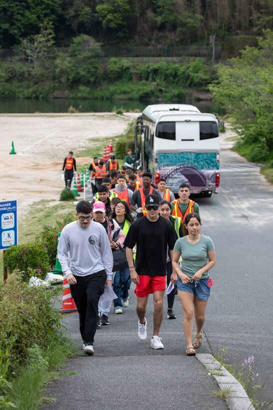 Volunteers from Marine Corps Air Station Iwakuni walk to the Kintaikyo Bridge to start picking up trash during a clean-up at the Kintaikyo Bridge, Iwakuni, Japan, April 21, 2025. The Marine Corps Community Services Iwakuni, Single Marine Program hosted a bridge clean-up as part of the SMP Days of Service, a five-day series of events where service members from Marine Corps Air Station Iwakuni volunteer to build stronger relationships and give back to the community. (U.S. Marine Corps photo by Sgt. Randall Whiteman)