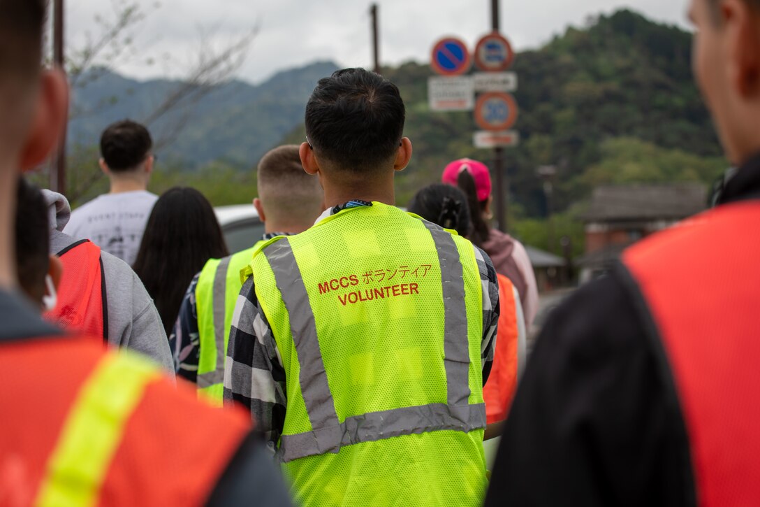 Volunteers from Marine Corps Air Station Iwakuni walk to the Kintaikyo Bridge during a clean-up at the Kintaikyo Bridge, Iwakuni, Japan, April 21, 2025. The Marine Corps Community Services Iwakuni, Single Marine Program hosted a bridge clean-up as part of the SMP Days of Service, a five-day series of events where service members from Marine Corps Air Station Iwakuni volunteer to build stronger relationships and give back to the community. (U.S. Marine Corps photo by Sgt. Randall Whiteman)