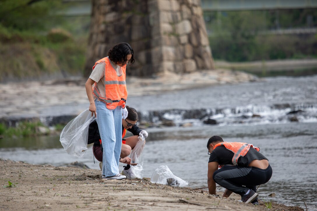 Volunteers from Marine Corps Air Station Iwakuni pick up trash alongside the riverbank during a clean-up at the Kintaikyo Bridge, Iwakuni, Japan, April 21, 2025. The Marine Corps Community Services Iwakuni, Single Marine Program hosted a bridge clean-up as part of the SMP Days of Service, a five-day series of events where service members from Marine Corps Air Station Iwakuni volunteer to build stronger relationships and give back to the community. (U.S. Marine Corps photo by Sgt. Randall Whiteman)