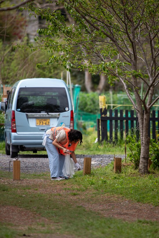 U.S. Marine Corps Lance Cpl. Stephanie Rodriguez, an electrician with Marine Air Control Squadron (MACS) 4, 1st Marine Aircraft Wing, and a native of New Mexico, picks up trash during a clean-up at the Kintaikyo Bridge, Iwakuni, Japan, April 21, 2025. The Marine Corps Community Services Iwakuni, Single Marine Program hosted a bridge clean-up as part of the SMP Days of Service, a five-day series of events where service members from Marine Corps Air Station Iwakuni volunteer to build stronger relationships and give back to the community. (U.S. Marine Corps photo by Sgt. Randall Whiteman)