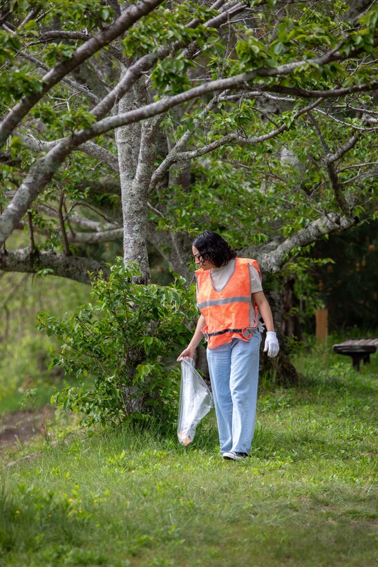 U.S. Marine Corps Lance Cpl. Stephanie Rodriguez, an electrician with Marine Air Control Squadron (MACS) 4, 1st Marine Aircraft Wing, and a native of New Mexico, searches for trash during a clean-up at the Kintaikyo Bridge, Iwakuni, Japan, April 21, 2025. The Marine Corps Community Services Iwakuni, Single Marine Program hosted a bridge clean-up as part of the SMP Days of Service, a five-day series of events where service members from Marine Corps Air Station Iwakuni volunteer to build stronger relationships and give back to the community. (U.S. Marine Corps photo by Sgt. Randall Whiteman)