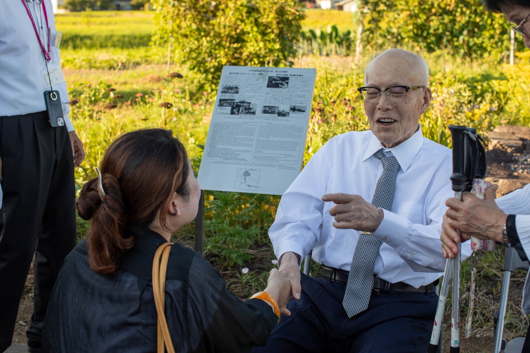 Shigeaki Mori, a Japanese historian and a survivor of the atomic bombing of Hiroshima, speaks with Hiromi Kawamoto, a community relations specialist with Headquarters and Headquarters Squadron (H&HS), Marine Corps Air Station Iwakuni, during a memorial event, Yanai, Japan, July 28, 2025. Local residents came together to support the memorial in Yanai, Japan, paying tribute to American and Japanese lives lost during World War II. (U.S. Marine Corps photo by Lance Cpl. Micah Taylor)