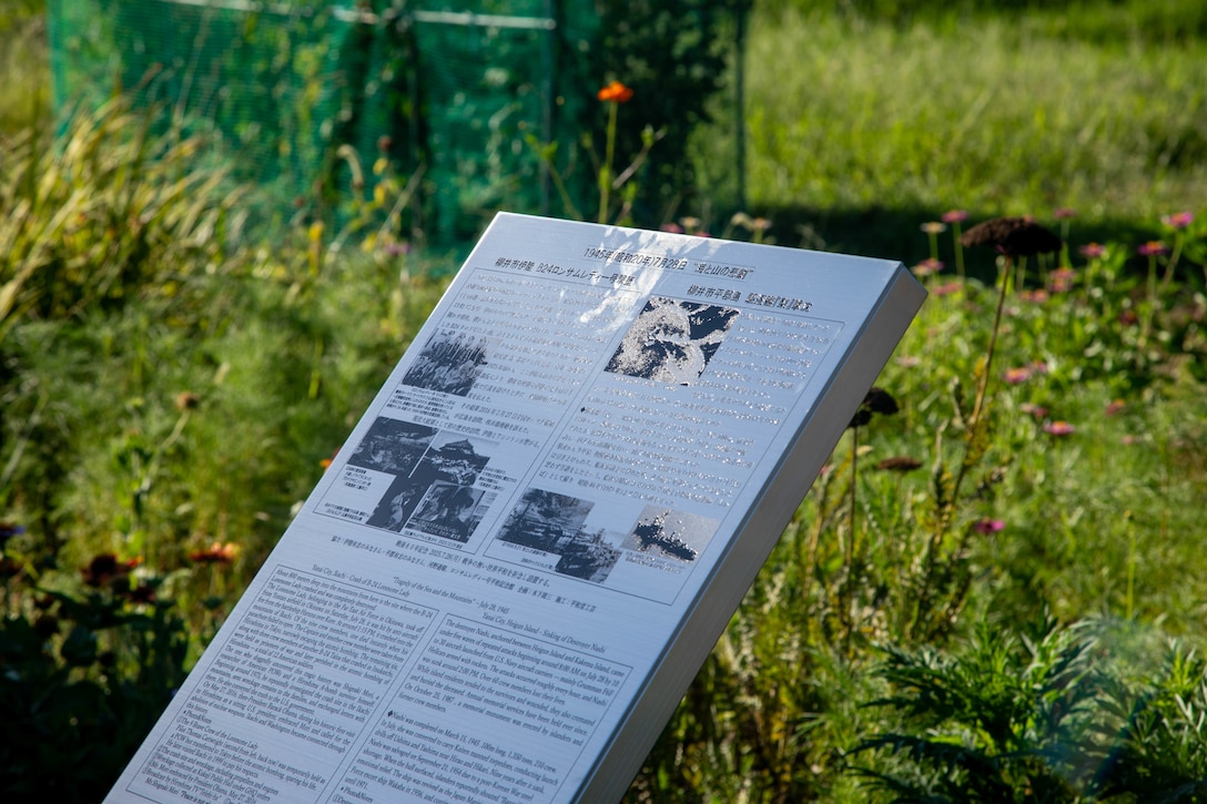 A commemorative plaque, written in both Japanese and English, provides historical details about the final mission and crash of the B-24 Liberator aircraft “Lonesome Lady”. The plaque honors the sacrifice of a fallen American aircrew and Japanese ship crew who lost their lives in two different incidents in the same region and on the same day. Local residents came together to support the memorial in Yanai, Japan, paying tribute to American and Japanese lives lost during World War II. (U.S. Marine Corps photo by Lance Cpl. Micah Taylor)